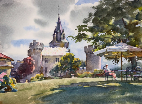 Watercolor painting of a castle with a person sitting under an umbrella in a garden.